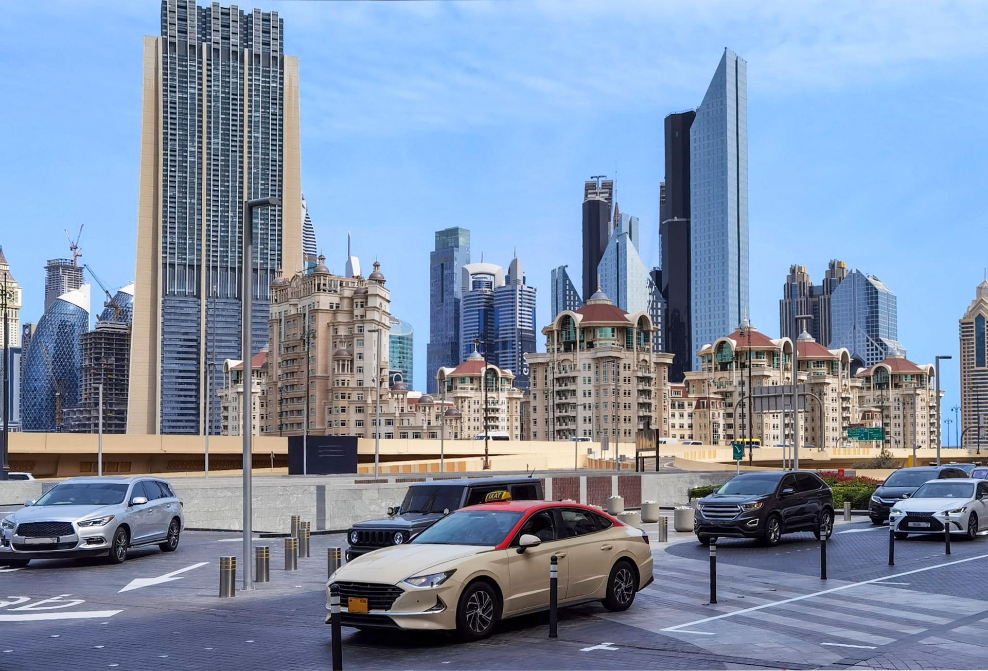 Dubai urban scene with luxury cars and a mix of modern skyscrapers and traditional buildings.